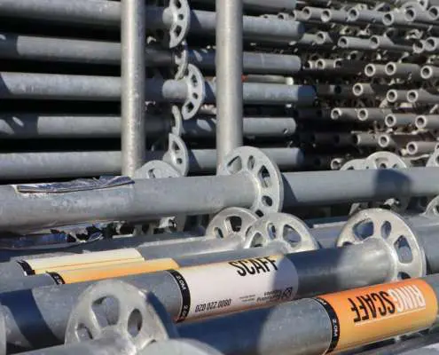 Galvanised steel Ringlock scaffolding stillage stacked with standards and ledgers.